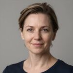 Портрет уверенного российского бизнесмена с дружелюбным взглядом на размытом нейтральном фоне студии